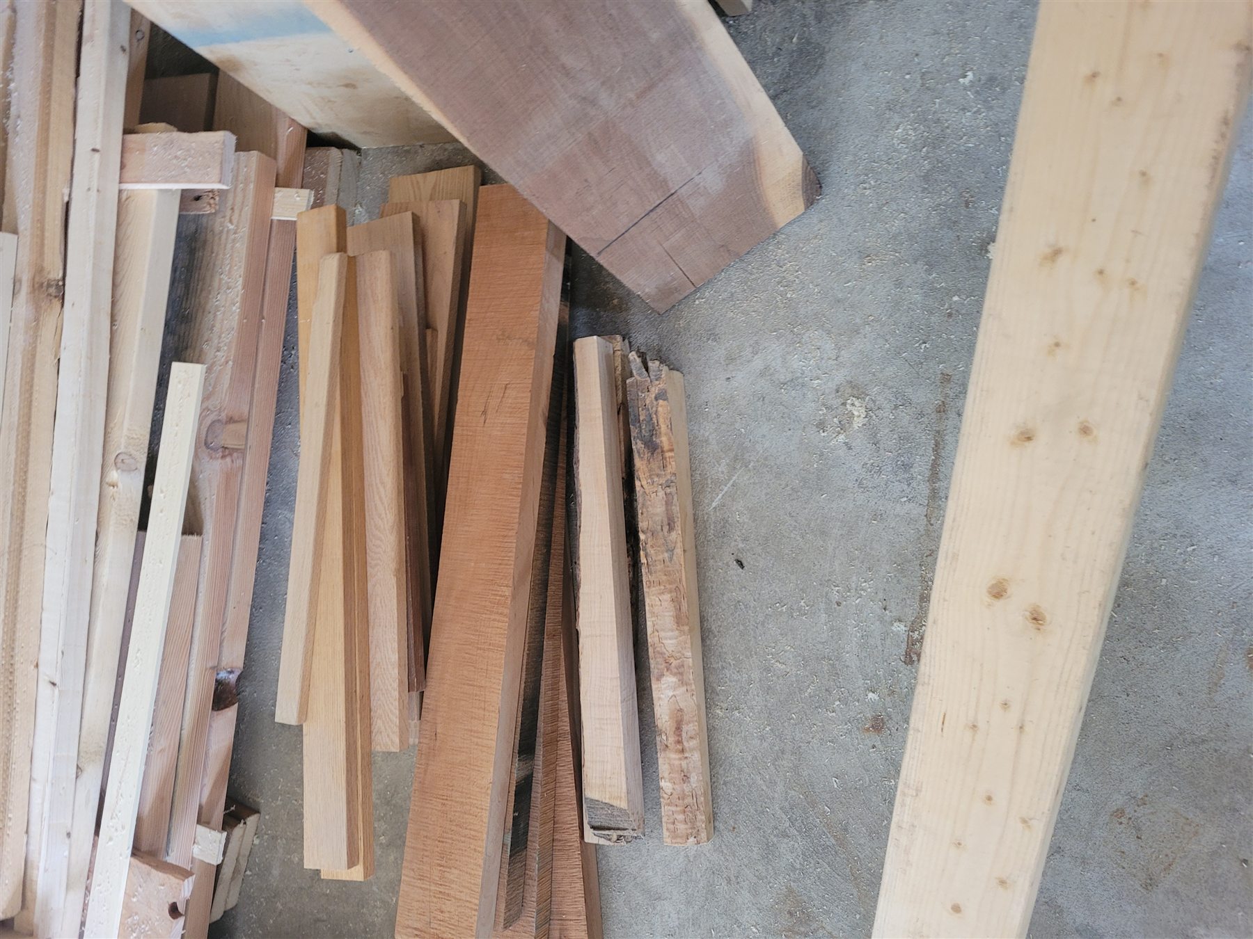 A varied stack of reclaimed and saved lumber in Keith’s workshop