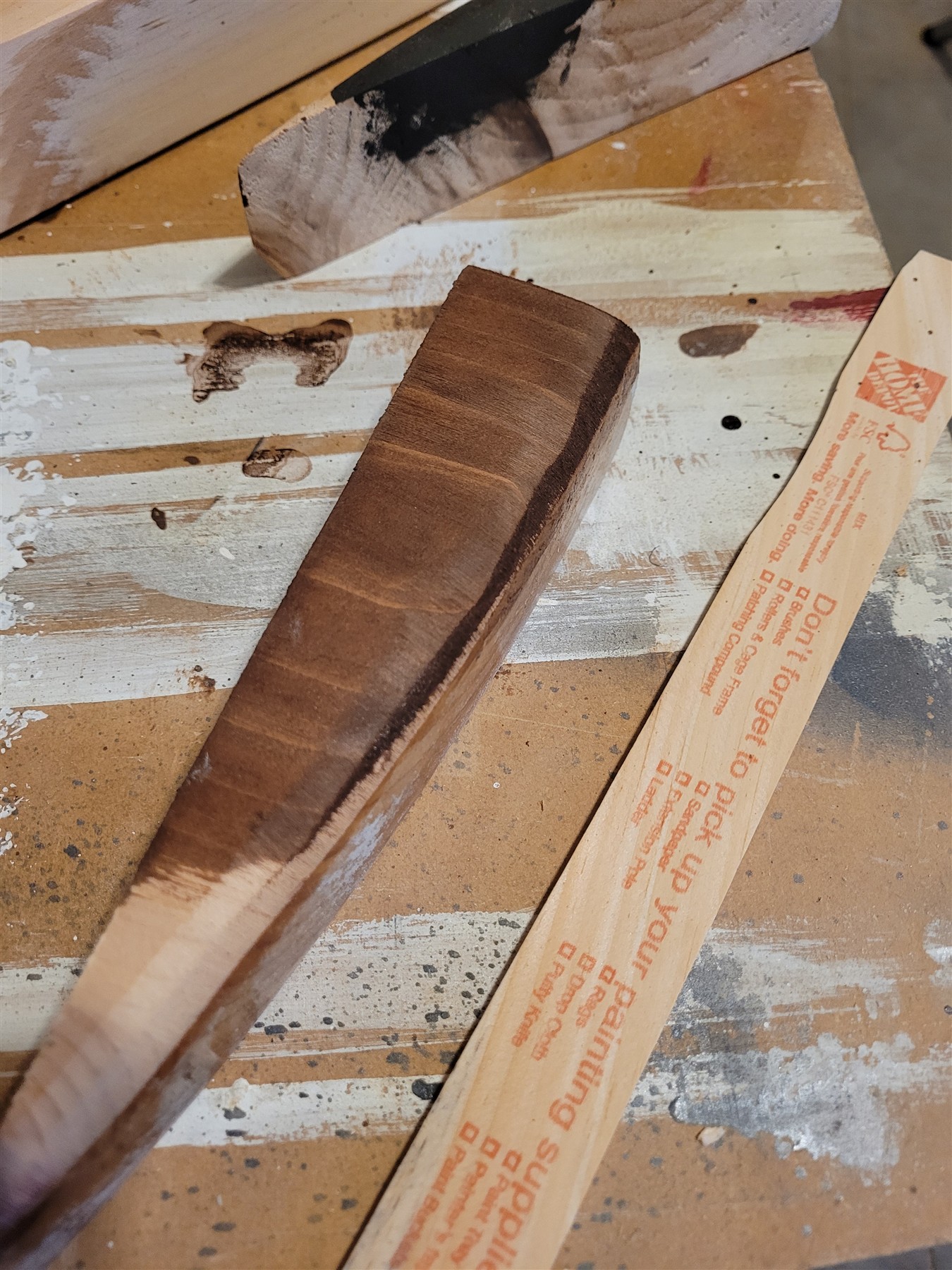 A curved offcut stripped and used to test the shelf stain
